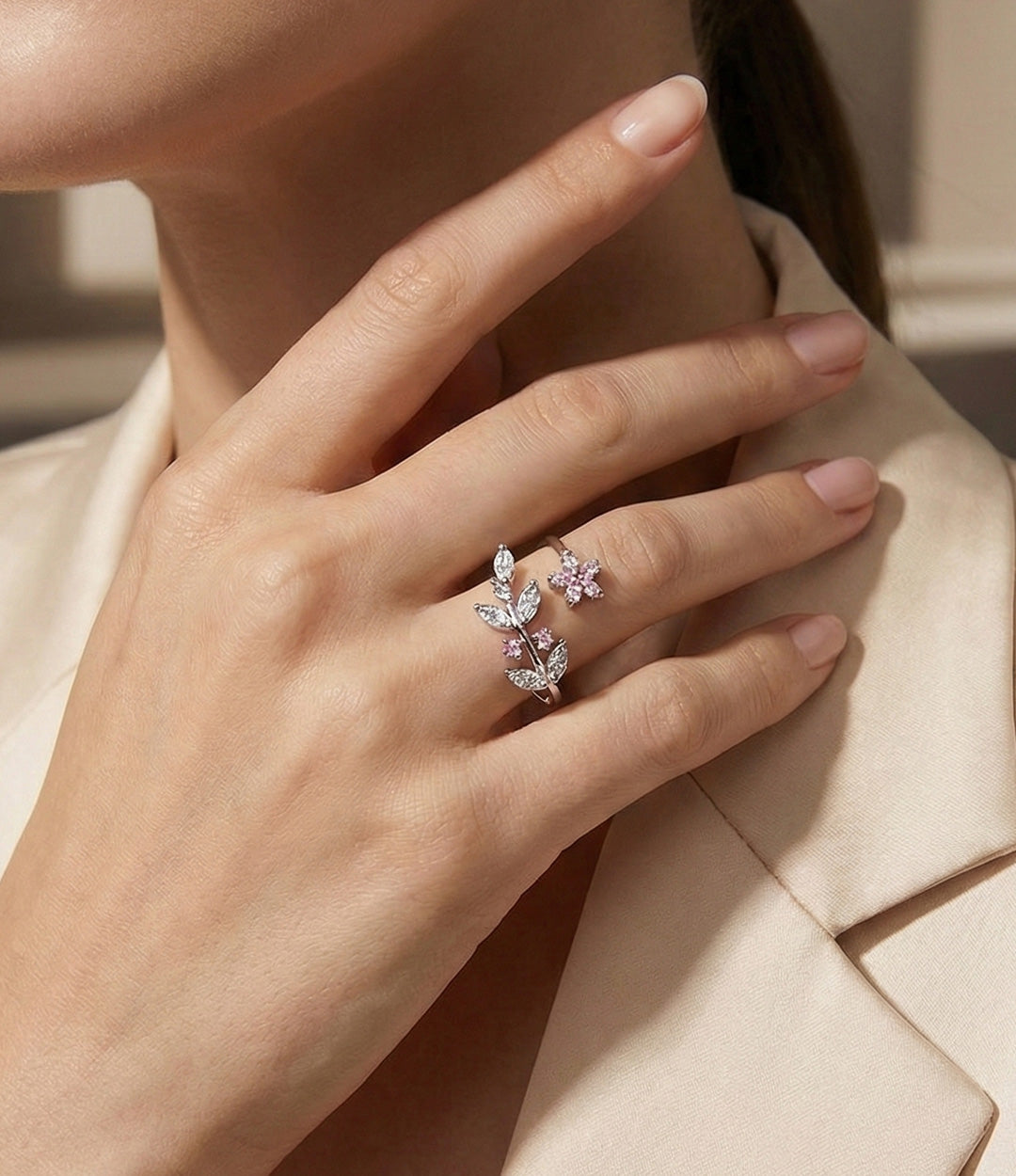 Woman's hand modeling the Garden Flower Ring on the ring finger, showcasing the delicate adjustable floral design and elegant fit.