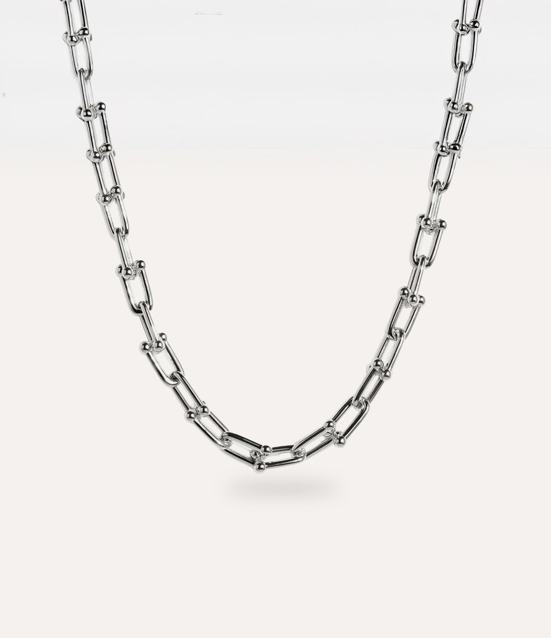 Minimalist 14k gold plated sterling silver necklace with sculptural chain design displayed flat.