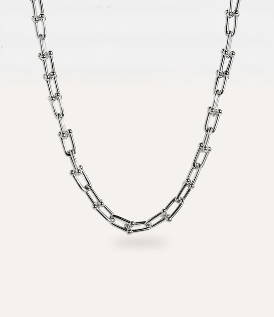 Minimalist 14k gold plated sterling silver necklace with sculptural chain design displayed flat.