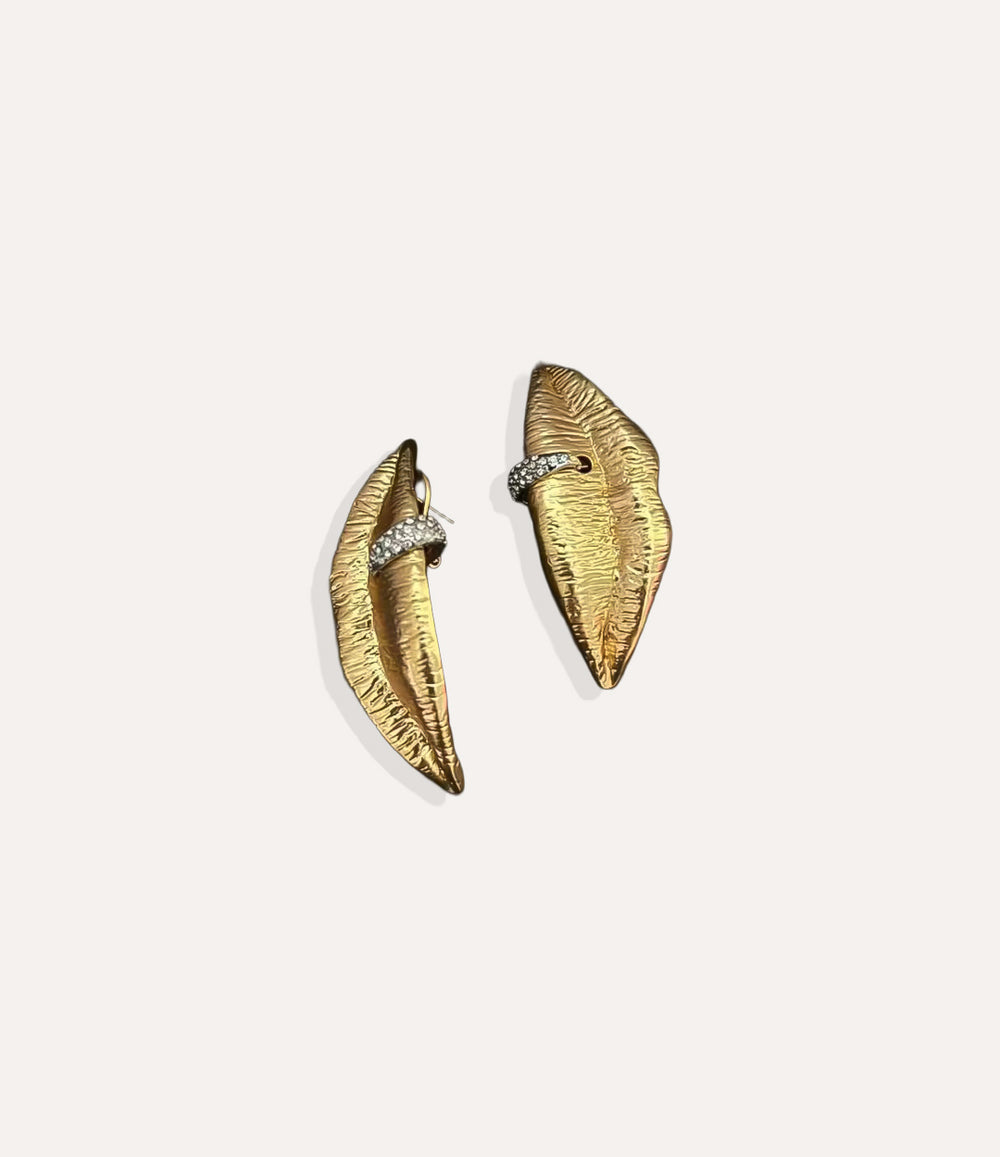 Close up of the Lips Pierced Earrings in gold highlighting the lips silhouette and shimmering diamond details.