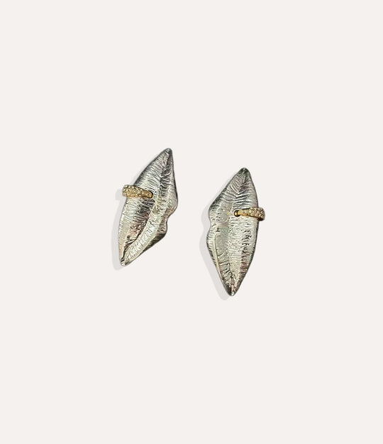 Close up of the Lips Pierced Earrings in silver showing the sleek design and delicate diamond accents.