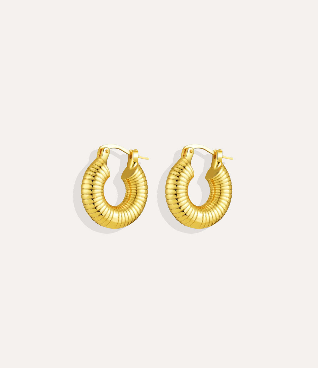 Product shot of the Liv Hoops in 18k gold plating displaying the grooved surface design and warm finish on a white background.