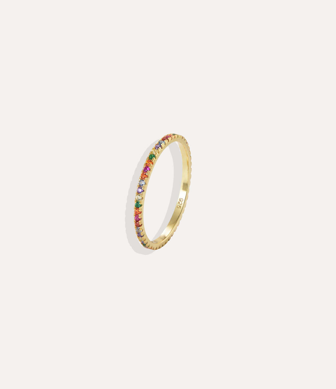 Gold ring with colorful stones on a white background