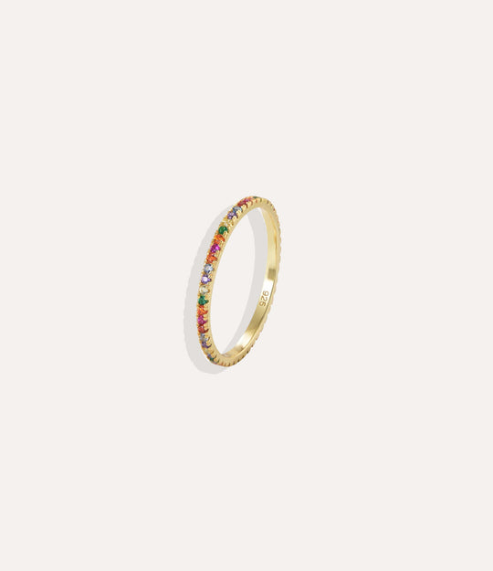Gold ring with colorful stones on a white background