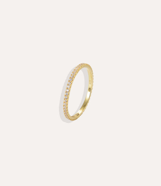 Gold ring with small diamonds on a white background