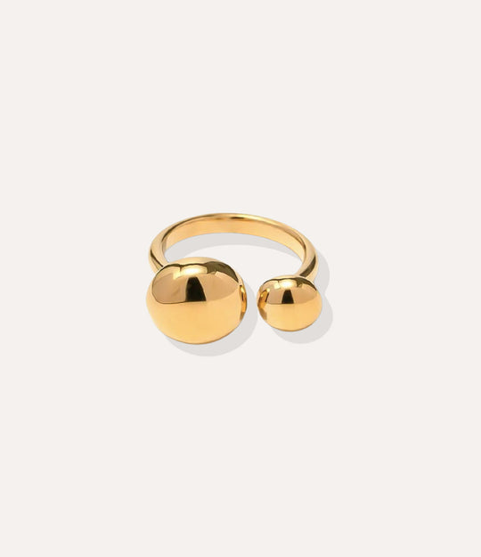 Mod Ball Ring in 18k gold plated finish, featuring a sleek open band with two gold spheres, isolated on a white background