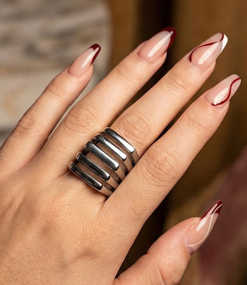 Woman's hand modeling the Mod Stack Ring in silver on the middle finger, showcasing the bold geometric shape and multi-stack illusion.