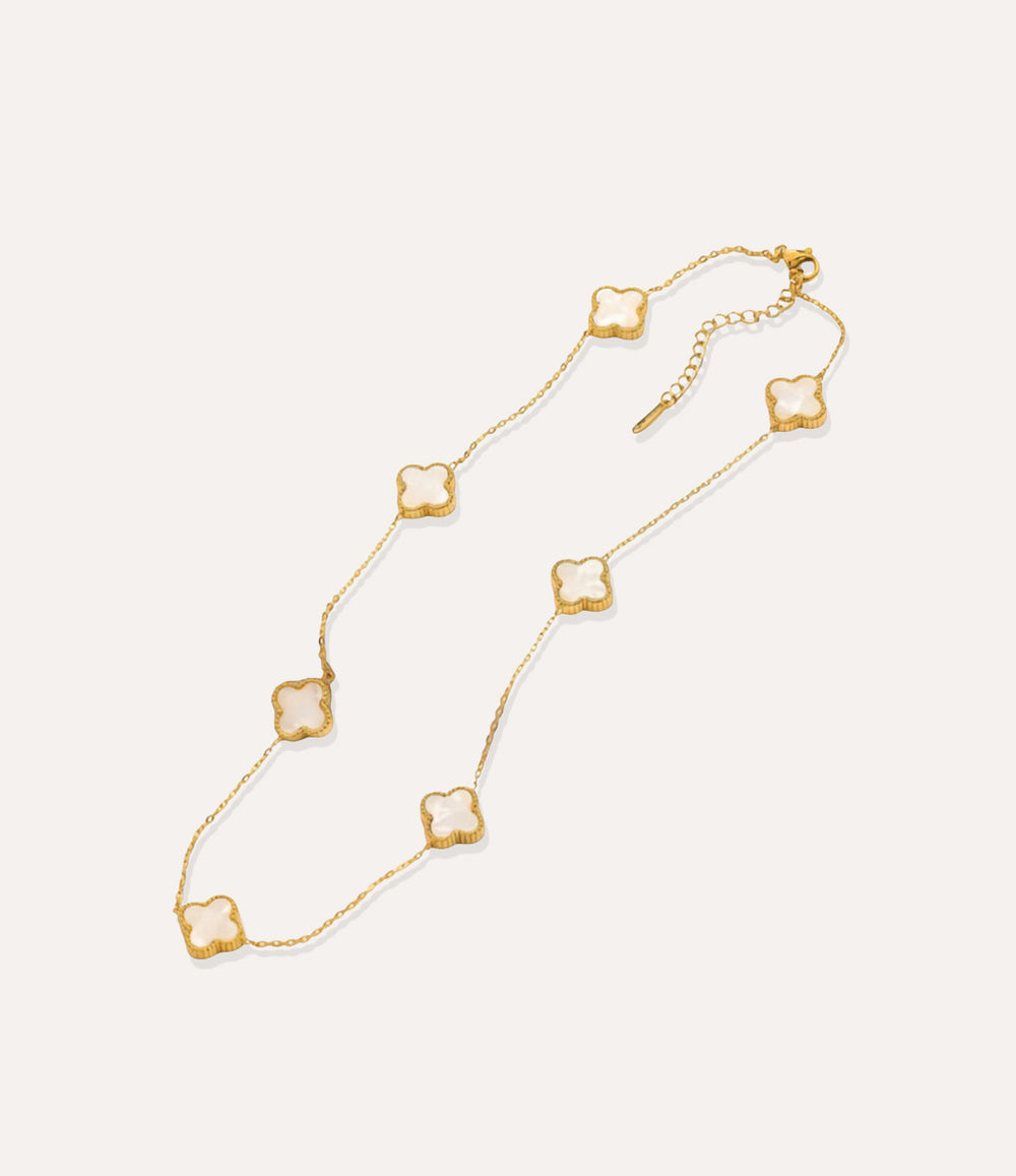 Gold and white multiple clover necklace displayed on white background