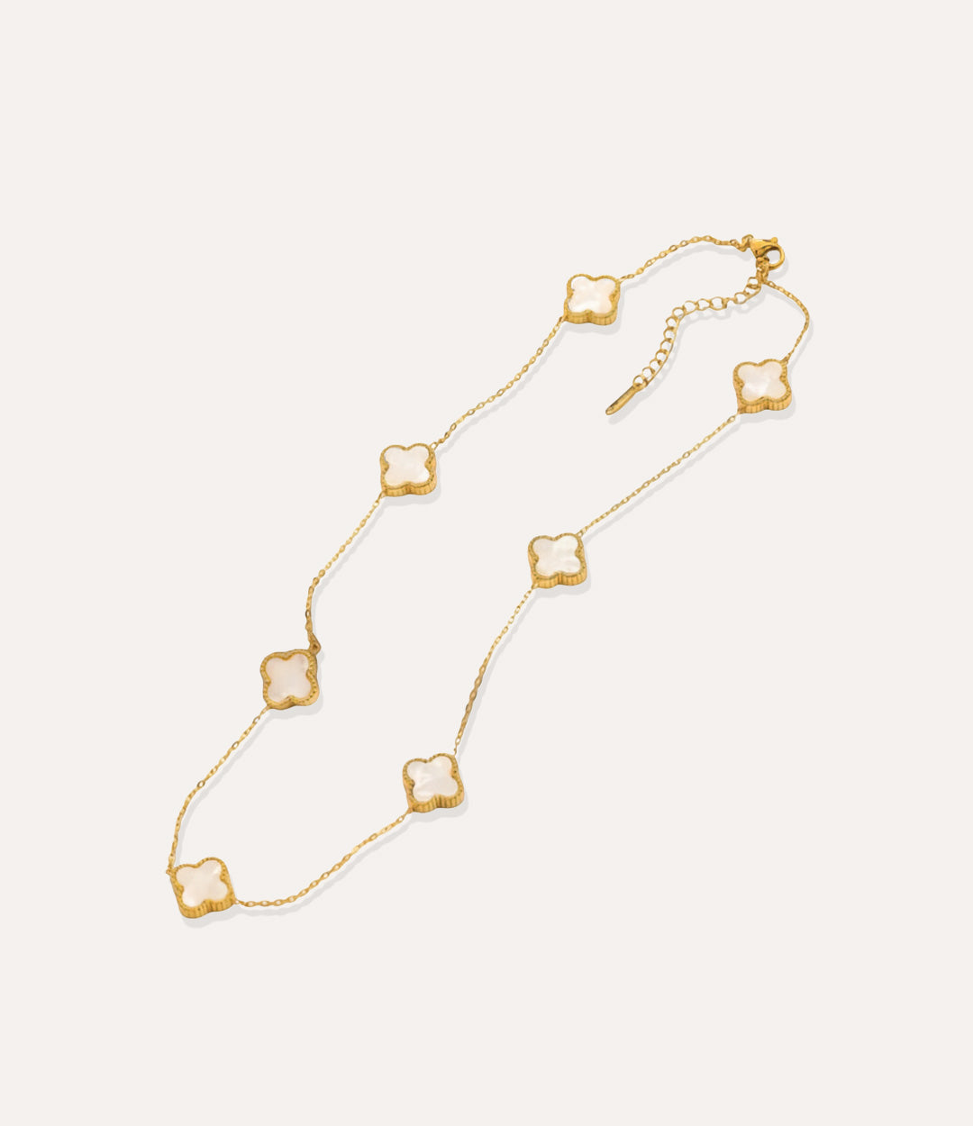 Gold and white multiple clover necklace displayed on white background