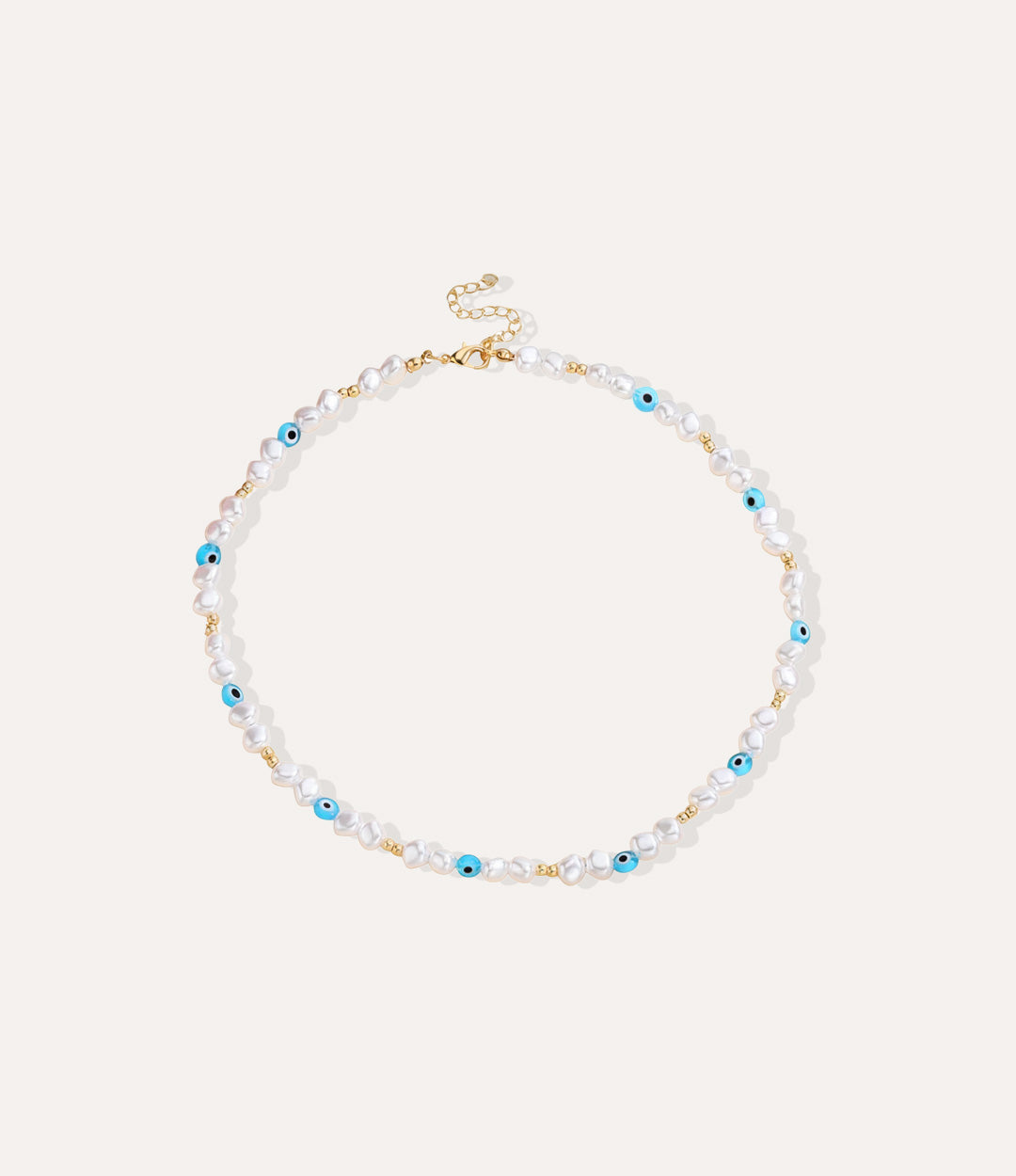 Mykonos necklace with freshwater pearls and blue evil-eye beads laid out on neutral background