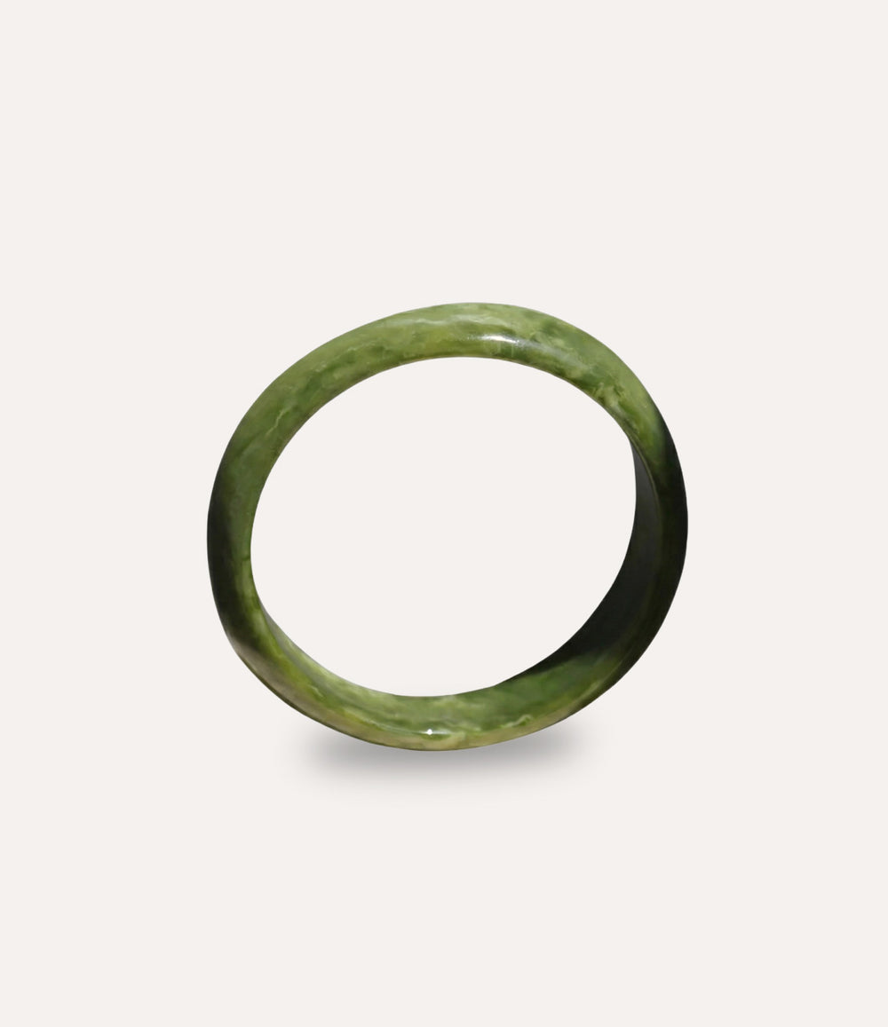Green acrylic resin bangle with irregular sculptural shape
