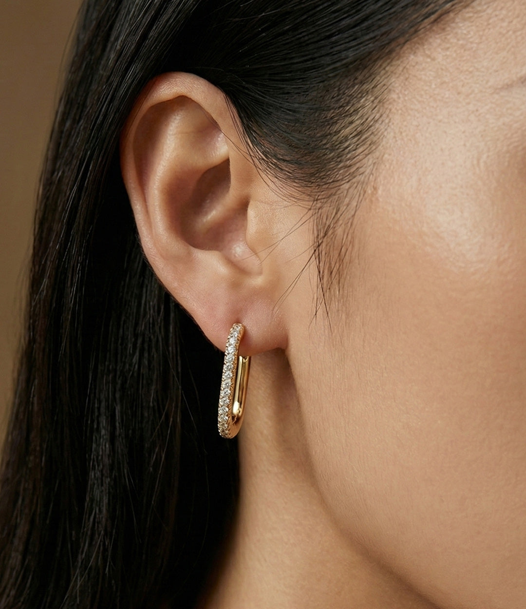 Model wearing Oval Diamond Hoops showcasing the elongated oval shape with sparkling diamond accents.