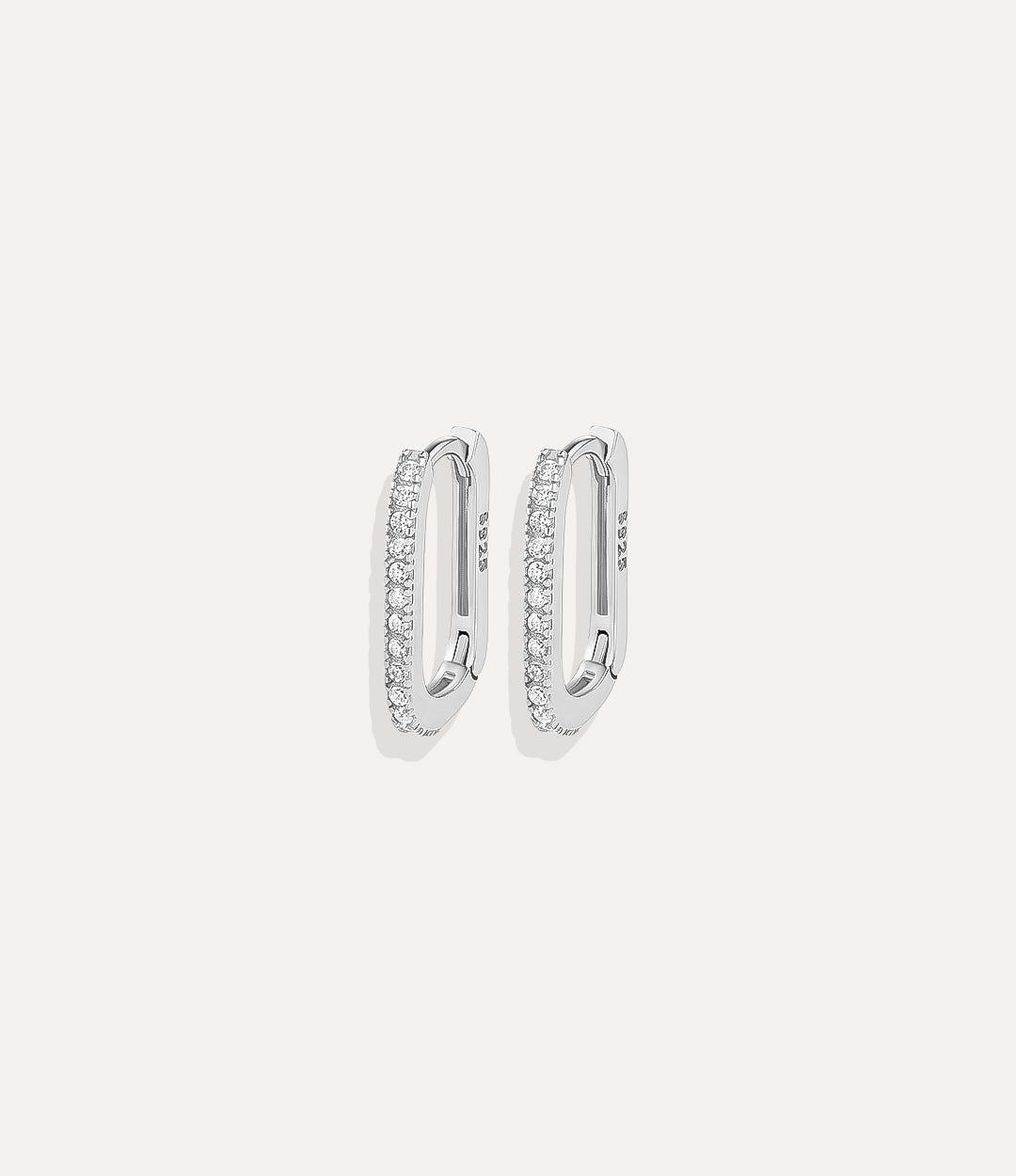 Close up of Oval Diamond Hoops in silver showing the sleek shape and subtle diamond sparkle.