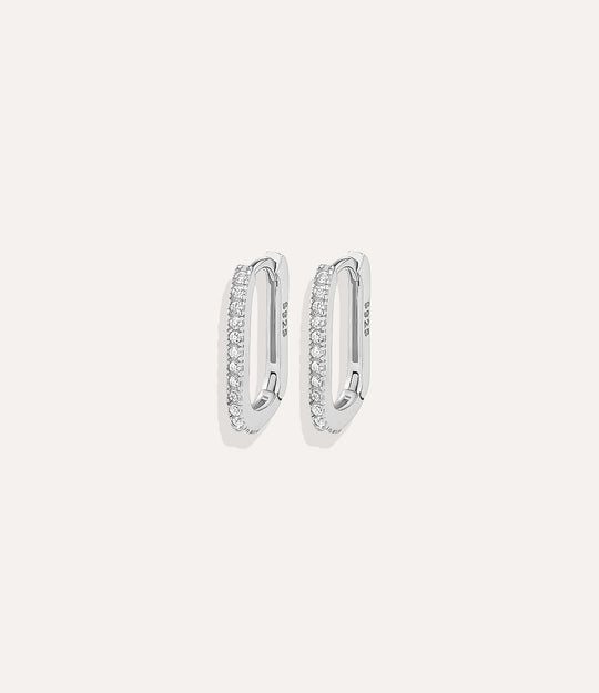 Close up of Oval Diamond Hoops in silver showing the sleek shape and subtle diamond sparkle.