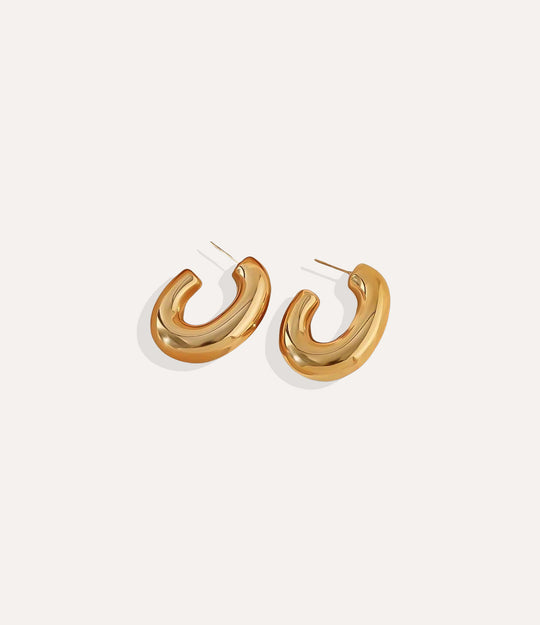 Gold hoop earrings on a white background