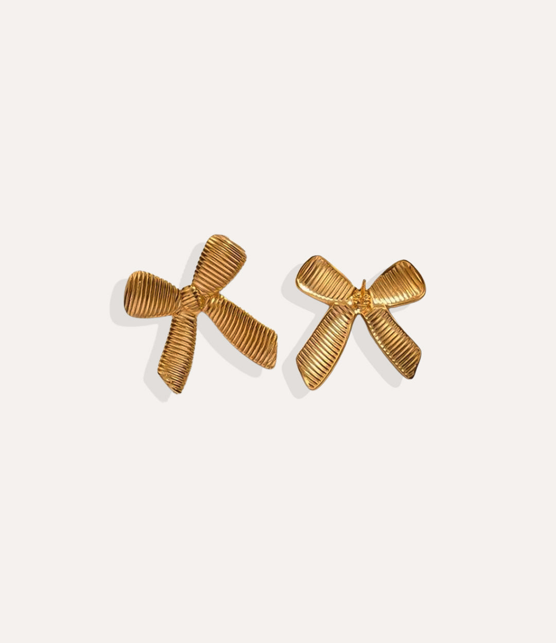 Product shot of the Oversized Bow Earrings in 18k gold plating displaying the smooth ribbon curves and high shine finish on a white background.