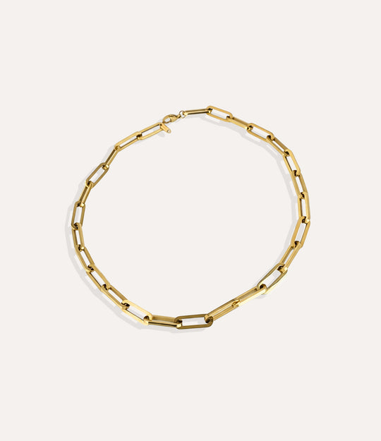 Oversized gold paperclip necklace crafted in 14k gold plated stainless steel on a neutral background