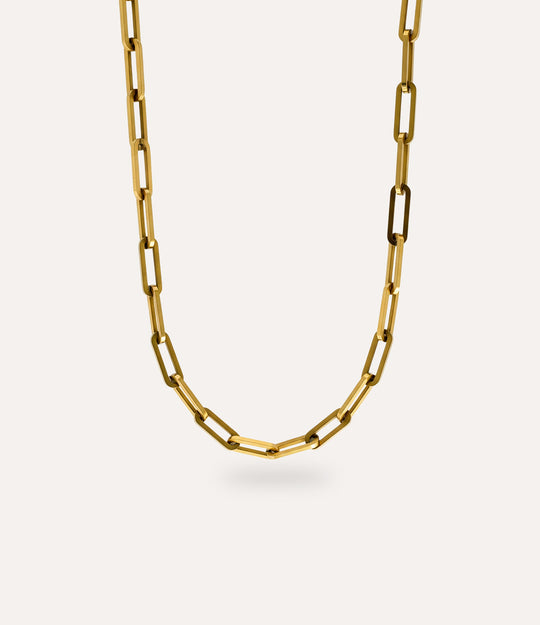 Close-up detail of oversized paperclip chain links showing polished gold finish