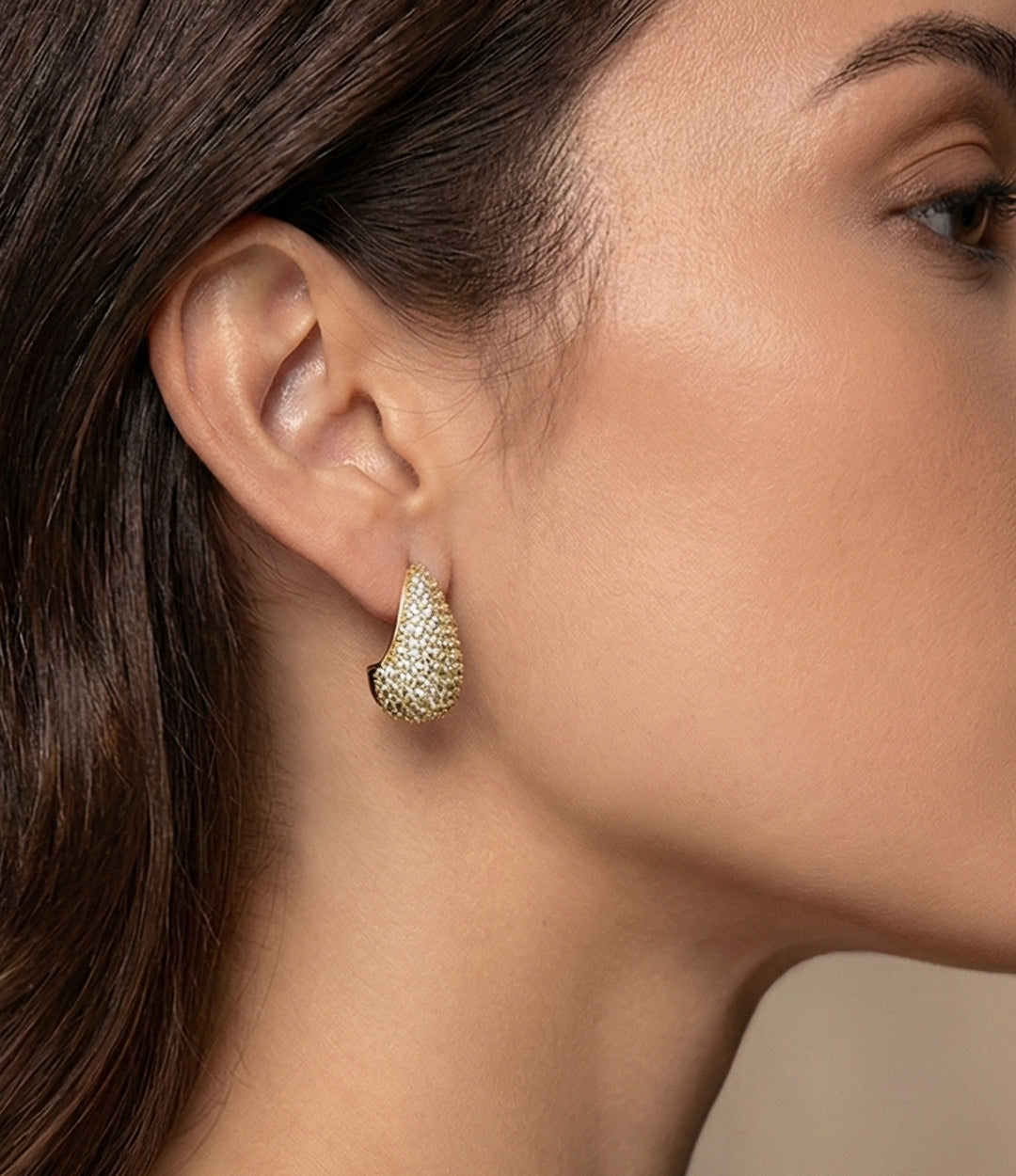 Close up of a model wearing the Pave Diamond Tear Drop Earring in gold showing the elegant drop shape and sparkling pave details against a neutral background.
