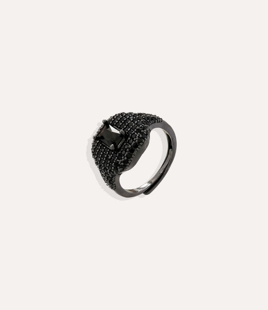 Black ring with embedded stones on a white background