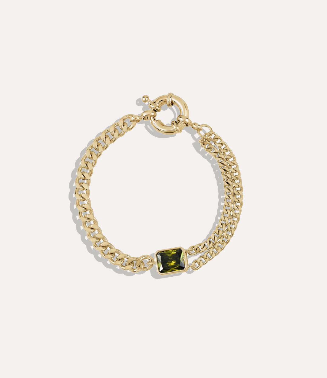 Peridot Chain Bracelet featuring two different chain styles and a green peridot stone on a neutral background.