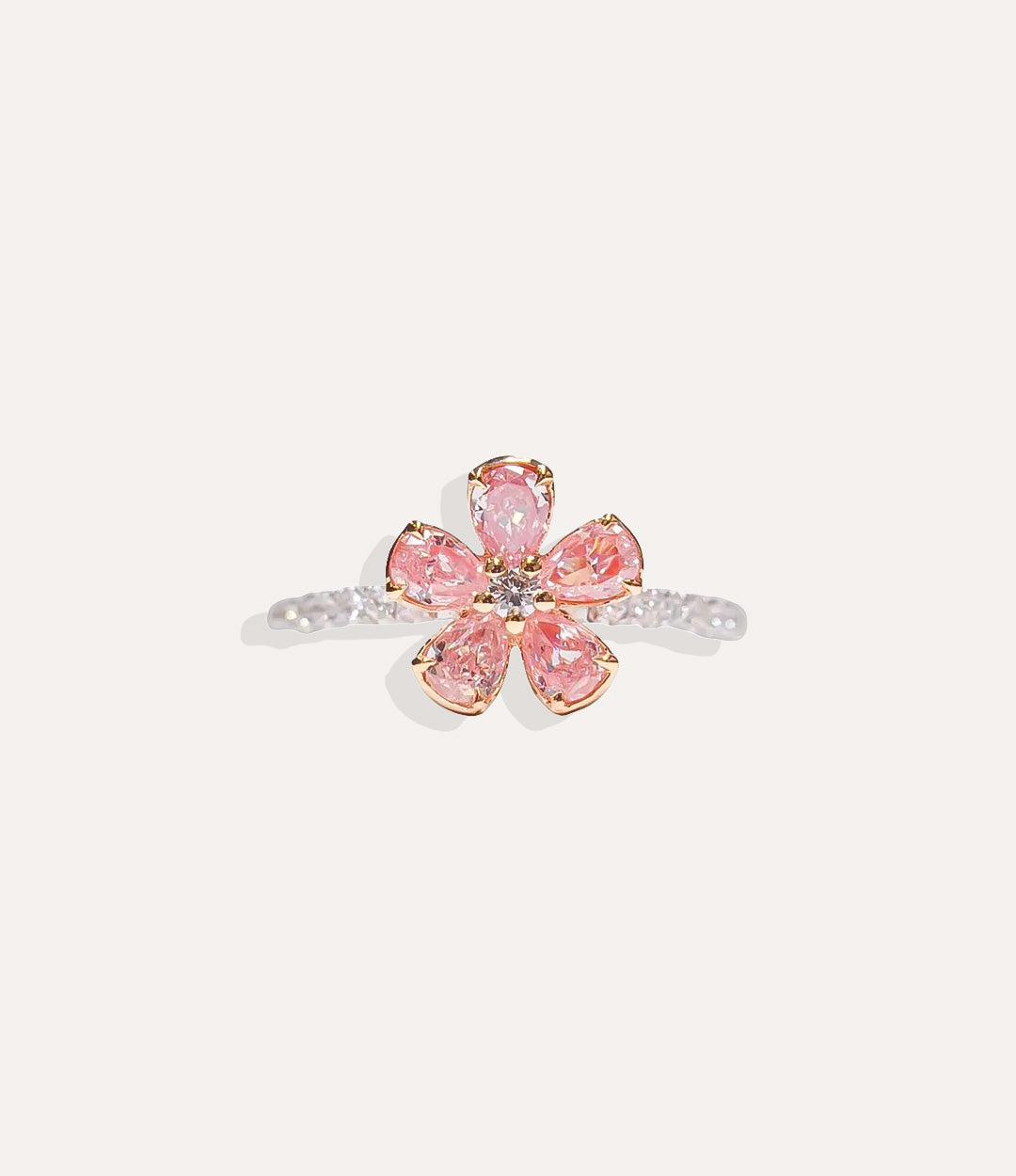 Sterling Silver Pink Flower Ring isolated on white, highlighting the polished silver band and brilliant diamond-adorned flower petals.