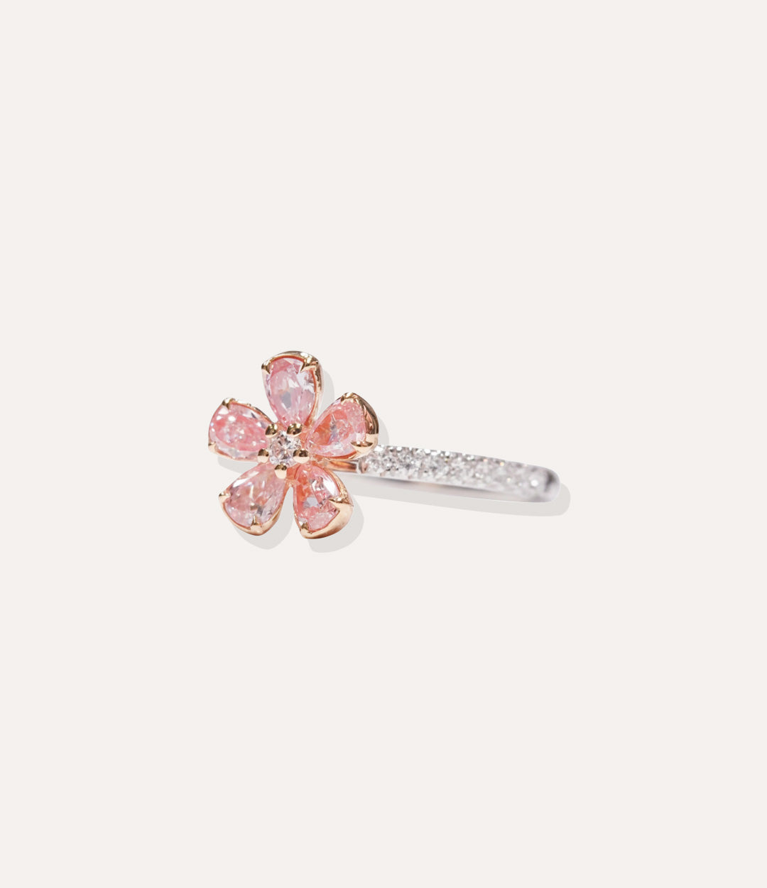 Sterling Silver Pink Flower Ring isolated on white, highlighting the polished silver band and brilliant diamond-adorned flower petals