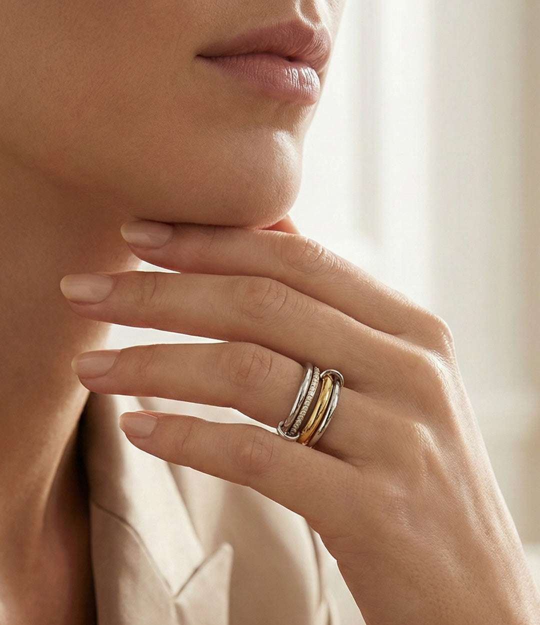 Close-up of a hand wearing a double ring with a blurred background