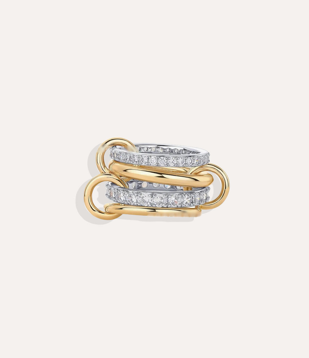Gold and silver ring with interlocking design on a light gray background
