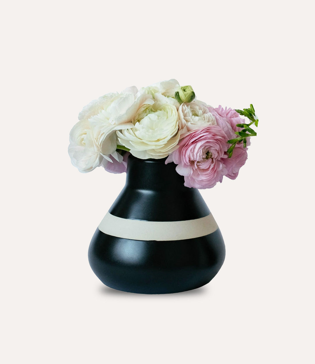 Black vase with white stripe holding flowers on a light gray background