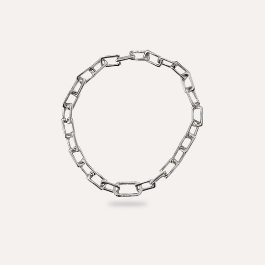 Silver chain necklace on a light gray background