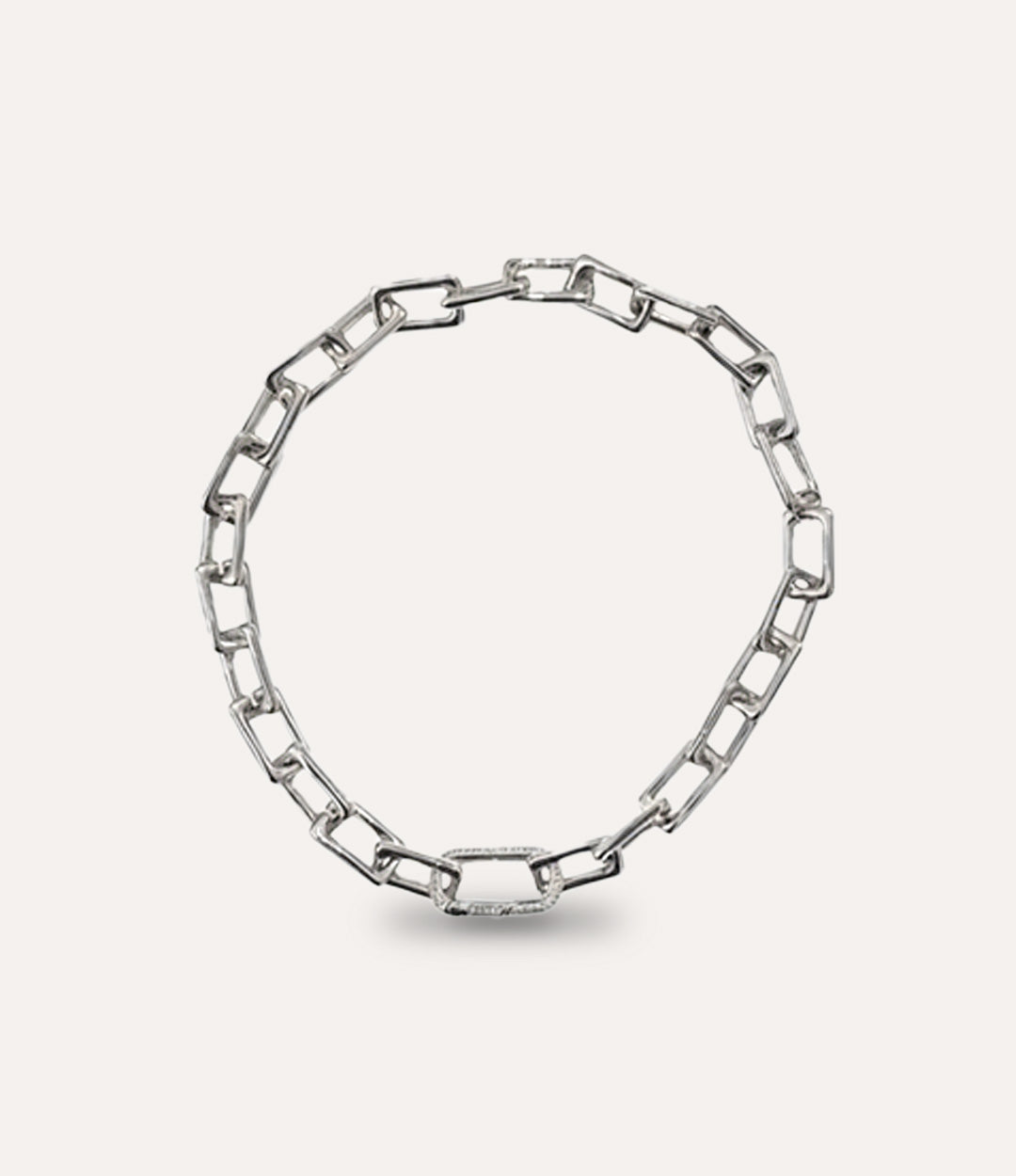 Silver chain necklace on a light gray background