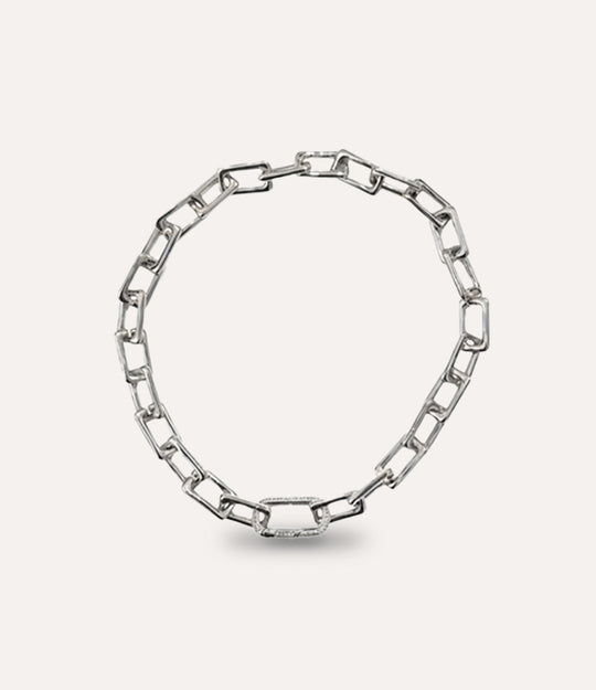 Silver chain necklace on a light gray background