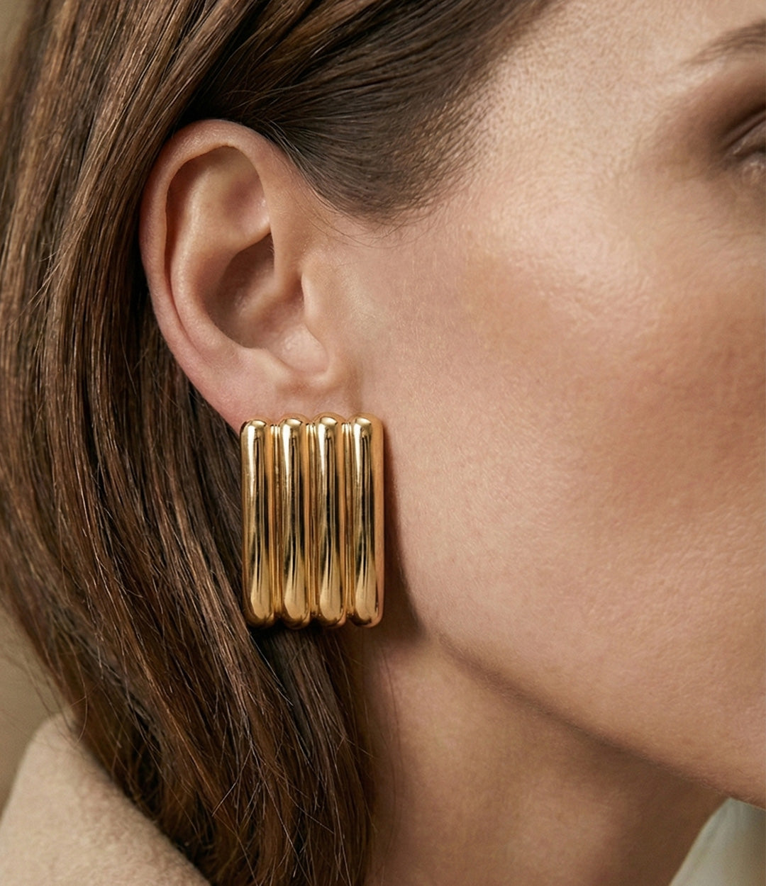 Model wearing the Ribbed Statement Earring, showcasing its oversized ribbed design and bold, elegant style.
