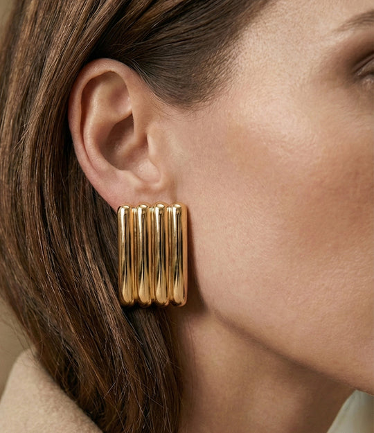 Model wearing the Ribbed Statement Earring, showcasing its oversized ribbed design and bold, elegant style.