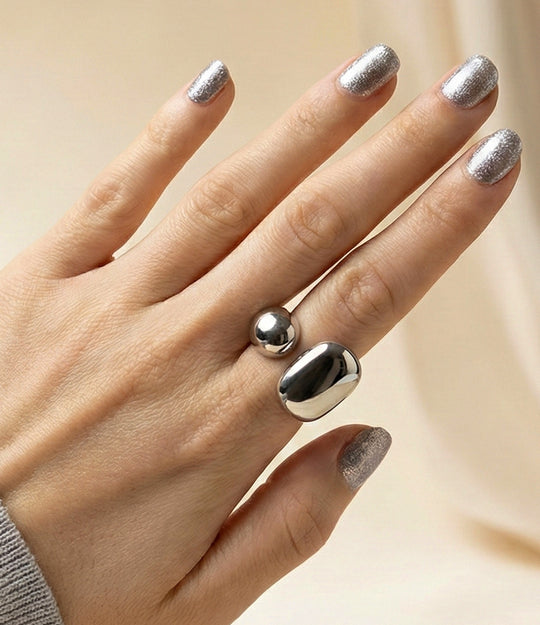 Model wearing riley Ring in 18k gold plated finish and silver, featuring a substantial band design made of waterproof stainless steel, isolated on a plain background.