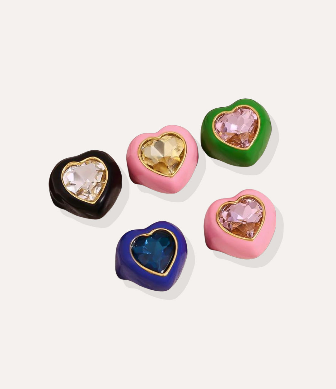 Set of heart-shaped jewelry with colorful gemstones on a white background