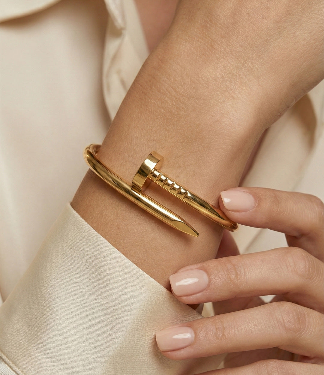Model wearing the Screw Bracelet showcasing its elegant screw motif and polished gold finish.
