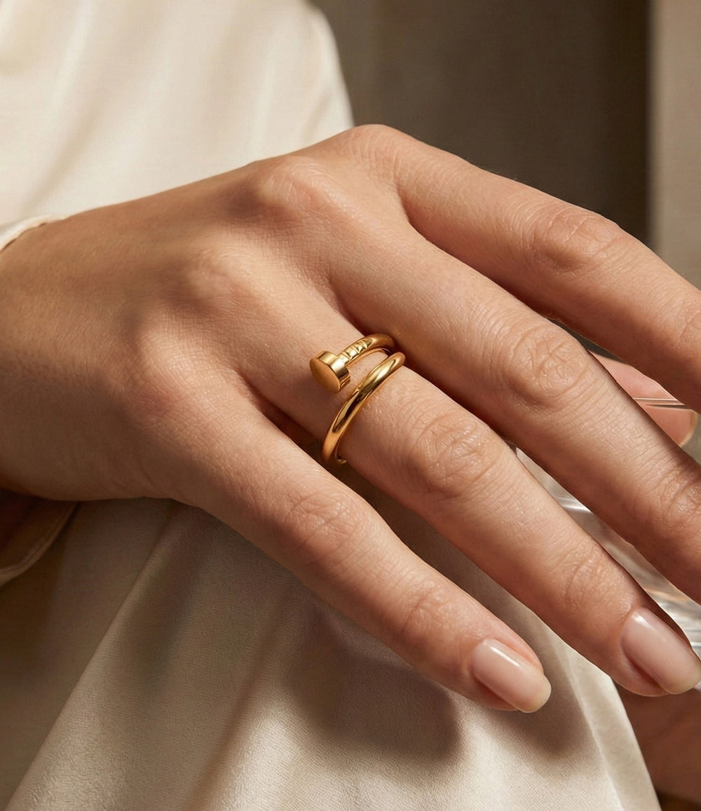Woman's hand modeling the Screw Ring on the ring finger, showcasing the sleek industrial design and modern screw head details.