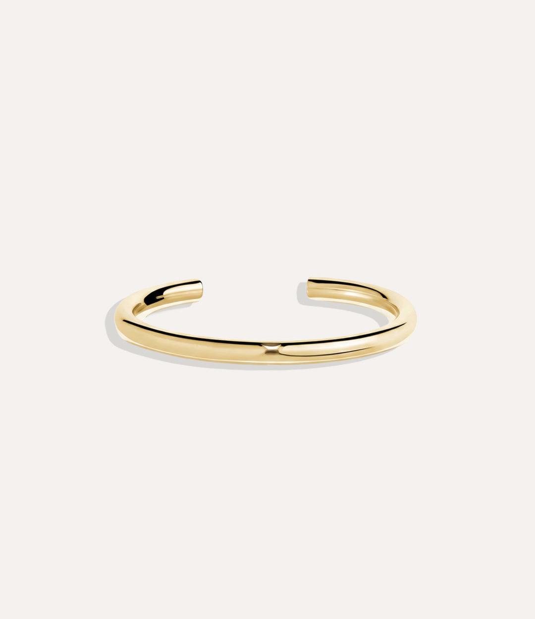 Skinny Essential Cuff in gold displayed on a neutral background with a sleek minimalist design.