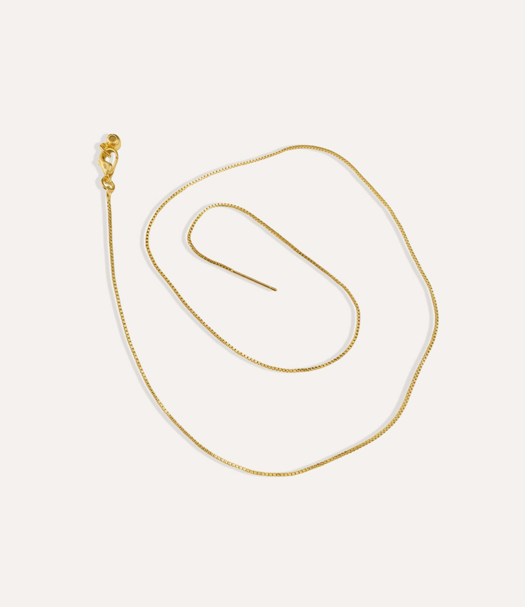 Elegant gold snake chain necklace with smooth, reflective finish.