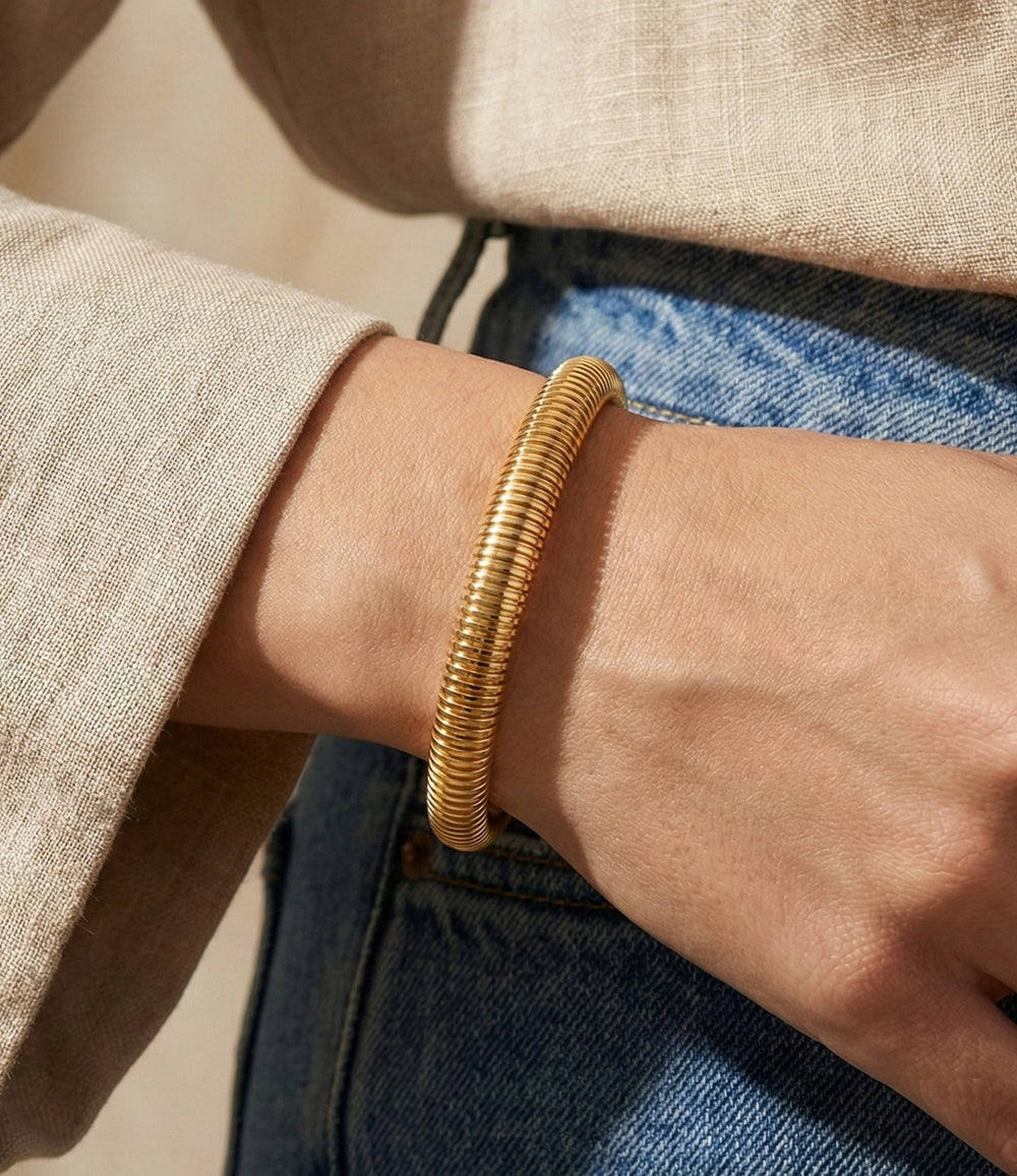 Model wearing the Snake Cuff in gold.