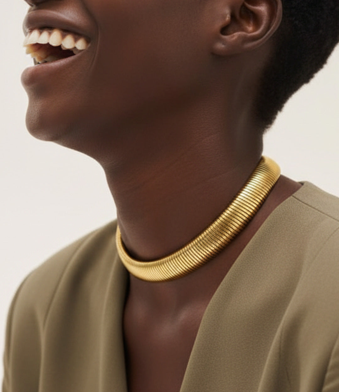Model wearing the 18K gold choker necklace with a green dress
