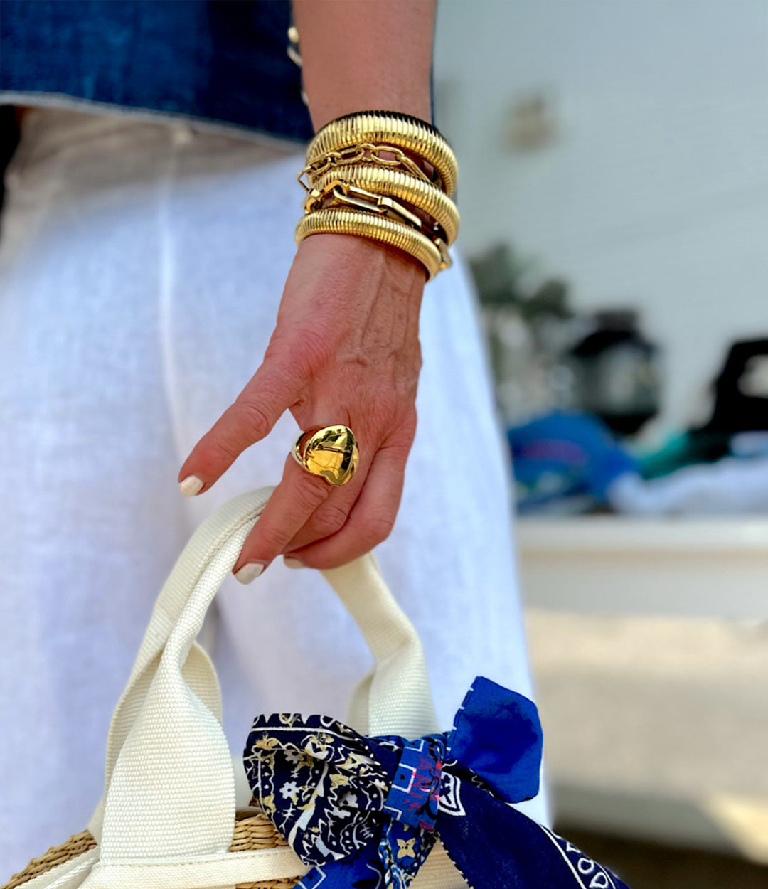 Model wearing the Snake Stretch Triple Bracelet, showcasing its elegant triple-stack snake-chain design and gold shine.