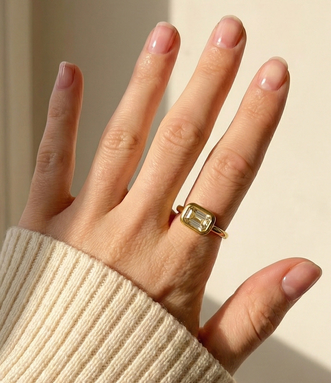 Model wearing the Solitaire Ring in 18k gold plated finish, featuring a single sparkling stone in a vintage setting, isolated on a plain background.