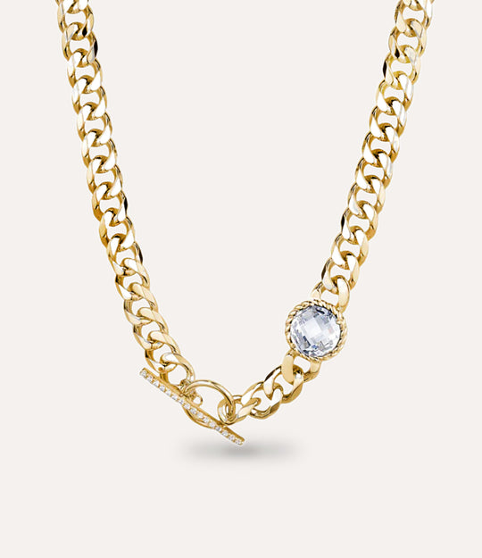 Gold chain necklace with a central white diamond on a white background
