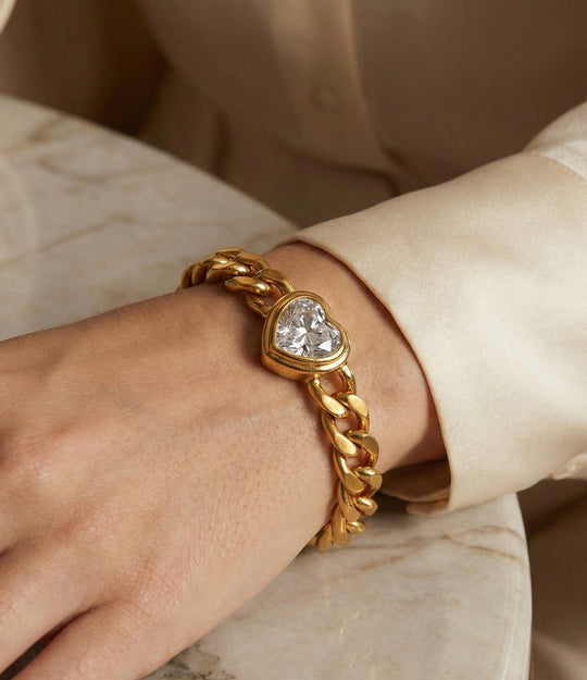 Model wearing the Solitaire Heart Chain Bracelet alone, showcasing the dainty heart pendant