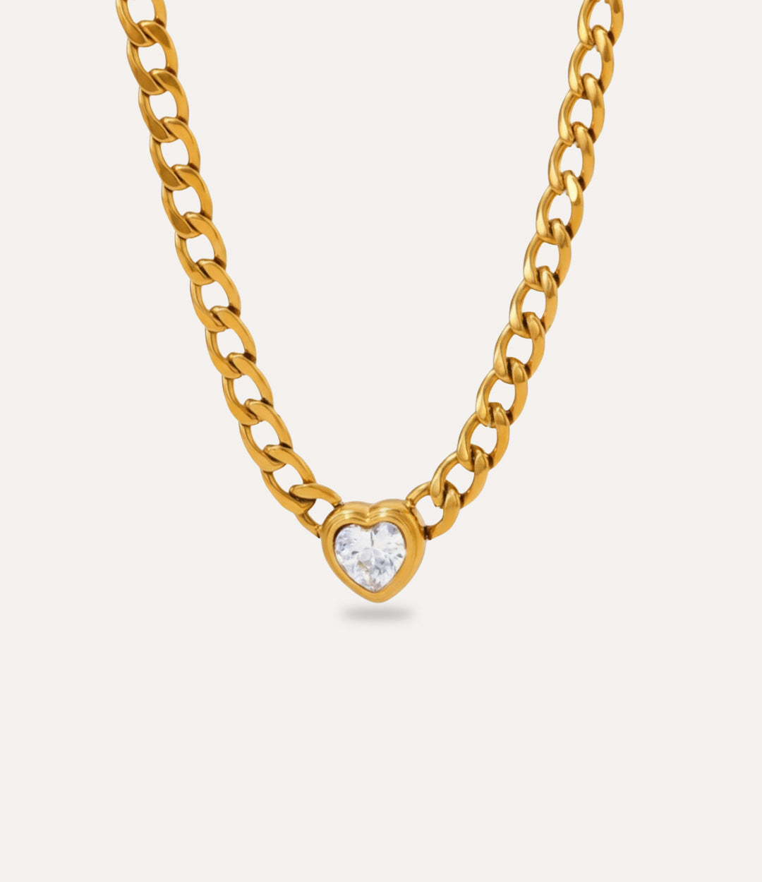 Chunky gold Solitaire Heart Chain Necklace with clear heart pendant on neutral background