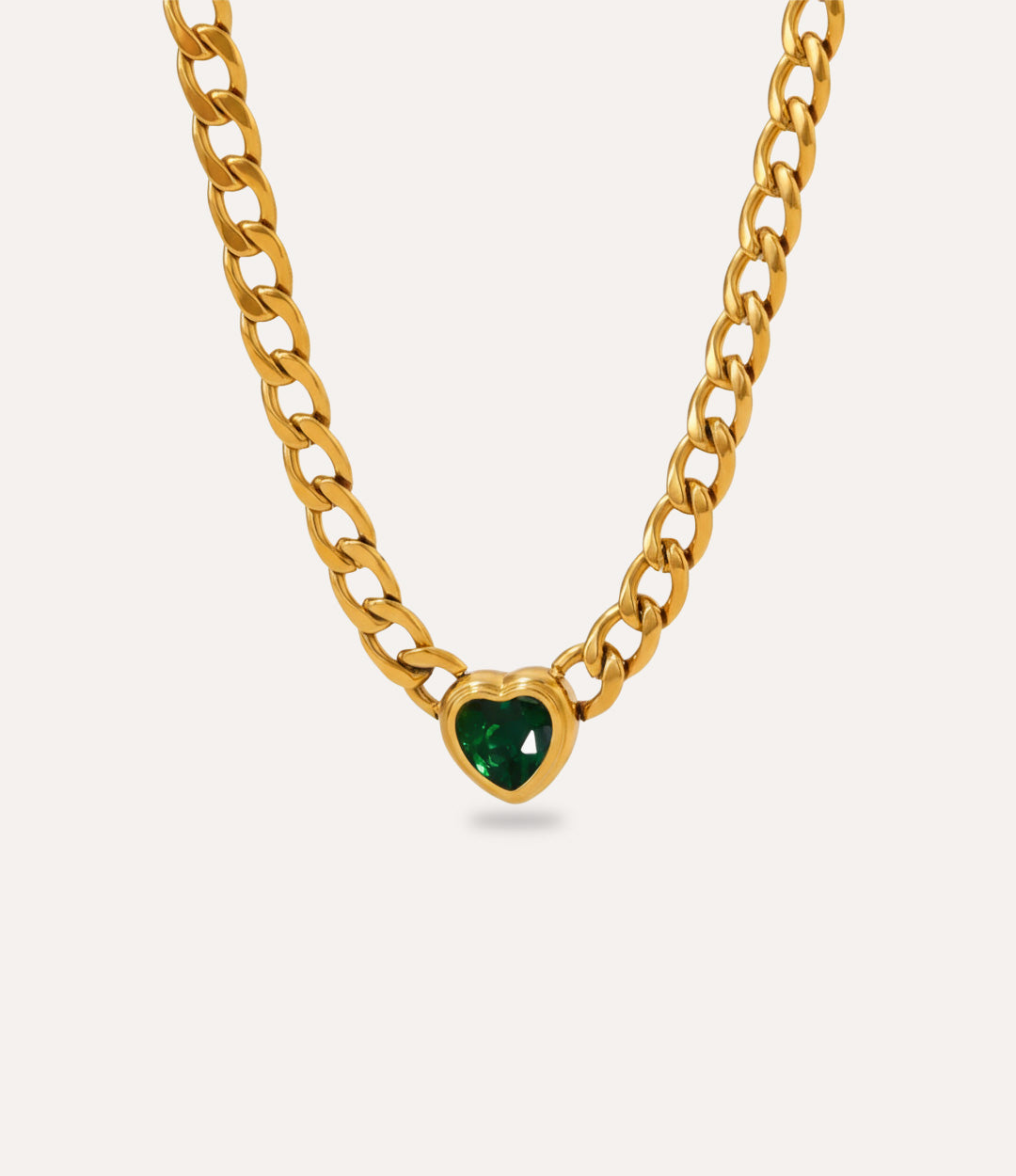 Chunky gold Solitaire Heart Chain Necklace with green heart pendant on neutral background