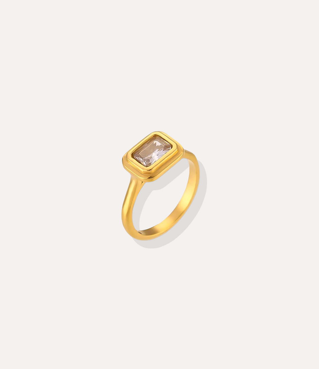 Solitaire Ring in 18k gold plated finish, featuring a single sparkling stone in a vintage setting, isolated on a white background.